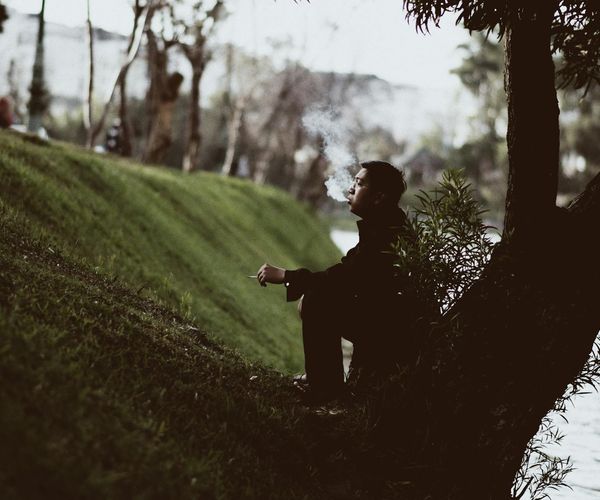 Person meditating peacefully in a nature setting by the water.